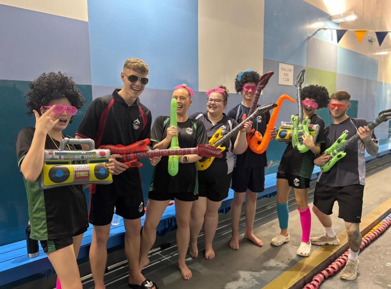 Academy staff dressed up with inflatable musical instruments for a themed lesson
